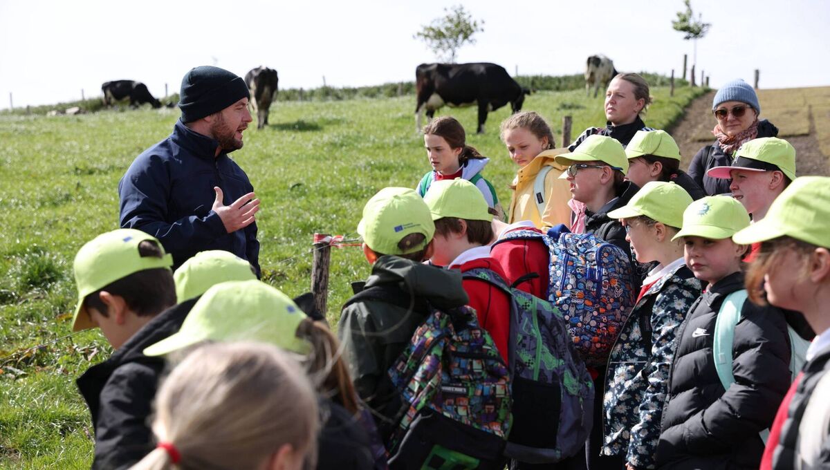 Eddie Holton, Agri Aware, with some hands-on learning at one of five National Dairy Council school farm visits taking place across the country this month. Picture: Tom Scott