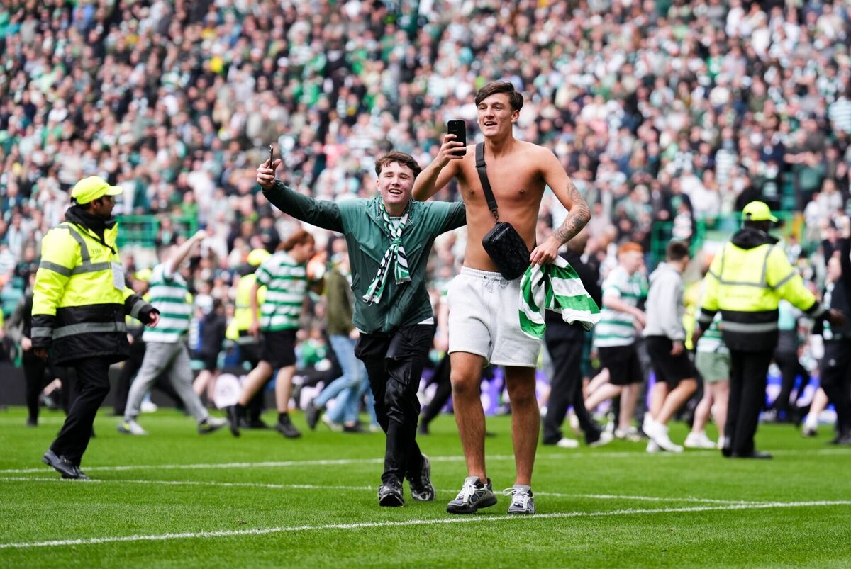 PITCH PERFECT: Celtic fans celebrate their side's victory over Heart of Midlothian following the William Hill Premiership match at Celtic Park, Glasgow. Pic: Andrew Milligan/PA Wire. PITCH PERFECT: Celtic fans celebrate their side's victory over Heart of Midlothian following the William Hill Premiership match at Celtic Park, Glasgow. Pic: Andrew Milligan/PA Wire.