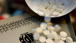 <p>Tablets are measured out in a high street pharmacy.</p>
