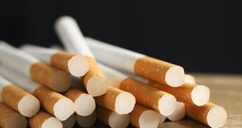image of several commercially made pile cigarette on black background. or Non smoking campaign concept, tobacco pattern top view