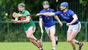 <p>FIGHT: Fr O'Neills' Kevin O'Sullivan looks to break clear of Barrs' duo James Murray and Jamie Burns in Sunday's Red FM Cork SHL Division 1 clash in Togher. Pic: Jim Coughlan.</p>