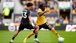 <p>Fulham’s Antonee Robinson (left) and Wolves’ Mateus Mane battle for the ball (David Davies/PA)</p>