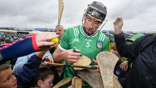 <p>BYRNES BABY BYRNES: Limerick's Diarmaid Byrnes signs autographs for young fans after the game. Pic: ©INPHO/James Lawlor.</p>