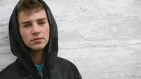 Boy with Black Hoodie in Front of White wall
