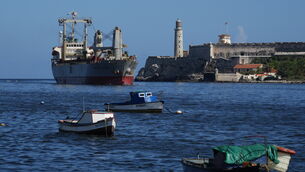 A cargo ship, top left, arrives in Havana Bay, Cuba, on Monday (Ramon Espinosa/AP)