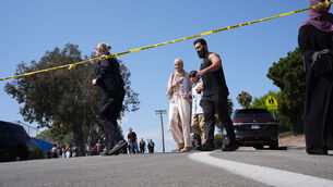 <p>Police tape is placed near the scene of a shooting outside the Islamic Centre of San Diego (Gregory Bull/AP)</p>