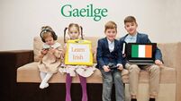 Four kids show inscription learn irish. Foreign language learning concept. Gaeilge.