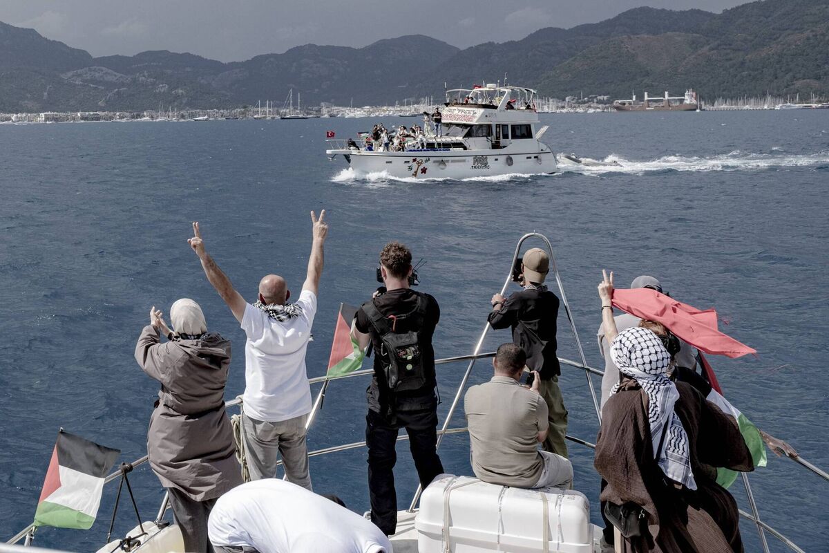 People raise V-signs and take photos from a boat decorated with Palestinian flags as another vessel displaying solidarity signs sails past near the port in Marmaris, Turkey, on May 14, 2026. The "Global Sumud Flotilla." (Picture: Murat Kocabas / Middle East Images / AFP via Getty Images) People raise V-signs and take photos from a boat decorated with Palestinian flags as another vessel displaying solidarity signs sails past near the port in Marmaris, Turkey, on May 14, 2026. The "Global Sumud Flotilla." (Picture: Murat Kocabas / Middle East Images / AFP via Getty Images)