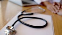 Doctor holding patient's hand, and reassuring his male patient helping hand concept.