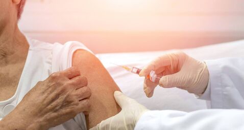 Senior vaccination concept. Elderly getting immune vaccine at arm for flu shot, pneumonia, and shingles(MMR) in hospital by nurs