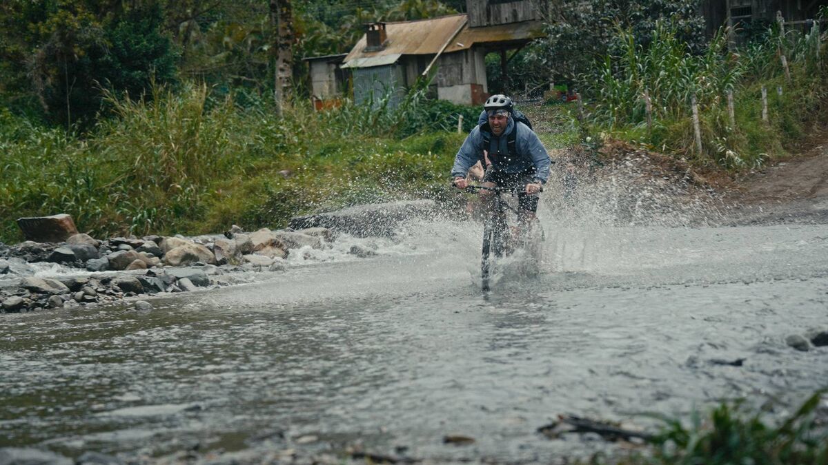 Michael Darragh MacAuley crossing a flooded track on bike in Costa Rica. Picture: RTE. Michael Darragh MacAuley crossing a flooded track on bike in Costa Rica. Picture: RTE.