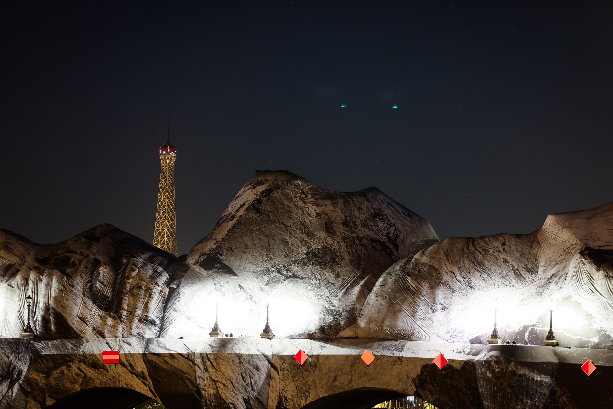 French artist JR begins his giant ‘cave’ art inflation over Paris’ oldest bridge