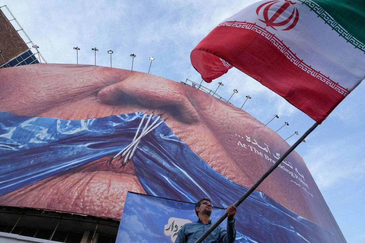 A man waves an Iranian flag for a pro-government campaign under a billboard with graphic showing Strait of Hormuz and sewn lips of US President Donald Trump in a square in downtown Tehran, Iran, Wednesday, May 6, 2026. (AP Photo/Vahid Salemi) A man waves an Iranian flag for a pro-government campaign under a billboard with graphic showing Strait of Hormuz and sewn lips of US President Donald Trump in a square in downtown Tehran, Iran, Wednesday, May 6, 2026. (AP Photo/Vahid Salemi)