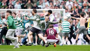 <p>OVER-EMOTIONAL: Celtic fans invaded the pitch after they won the title from Hearts on the last day of the season. Picture: Andrew Milligan/PA Wire.</p> <p>OVER-EMOTIONAL: Celtic fans invaded the pitch after they won the title from Hearts on the last day of the season. Picture: Andrew Milligan/PA Wire.</p>
