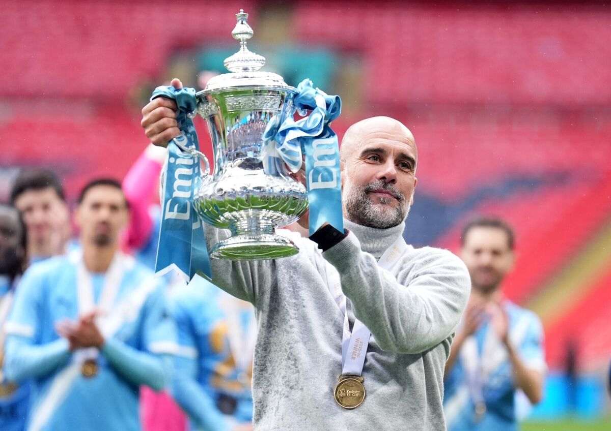 Manchester City manager Pep Guardiola celebrates with the FA Cup trophy following his side's victory over Chelsea at Wembley Stadium, London. Picture: Mike Egerton/PA