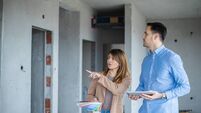 Real estate professionals inspecting home under renovation