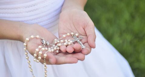 Rosary in Girl's hands