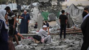 <p>A Palestinian man sits on the rubble at the site of a residential building targeted overnight by an Israeli strike, following a warning from the Israeli military to evacuate, in Deir el-Balah in the central Gaza Strip. Picture: Eyad Baba/Getty Images</p>