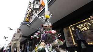 <p>Flowers left at the scene on Henry St where Yves Sakila was restrained, and later died. The incident has made headlines internationally. File picture: Sam Boal/Collins</p>