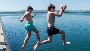 <p>Sunshine and temperatures of 25°C in Bantry brought people out to cool down in the sea. Attempting to cool off were Savo & Kasper Keane from Bantry. Picture: Andy Gibson.</p> <p>Sunshine and temperatures of 25°C in Bantry brought people out to cool down in the sea. Attempting to cool off were Savo & Kasper Keane from Bantry. Picture: Andy Gibson.</p>