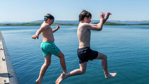 <p>Sunshine and temperatures of 25°C in Bantry brought people out to cool down in the sea. Attempting to cool off were Savo & Kasper Keane from Bantry. Picture: Andy Gibson.</p> <p>Sunshine and temperatures of 25°C in Bantry brought people out to cool down in the sea. Attempting to cool off were Savo & Kasper Keane from Bantry. Picture: Andy Gibson.</p>