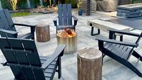 Outdoor sitting area fire pit in a chilly New York backyard in the fall. Enjoy landscaping, foliage and beauty while staying war