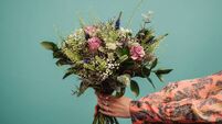 Woman holding a big bouquet of flowers
