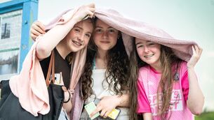 <p class="contextmenu internal_Caption">Lucy Chambers, Doireann Gannon, and Keelan McCarthy shelter under a towel as the weather takes a turn on Fountainstown Beach. Picture: Chani Anderson</p> <p class="contextmenu internal_Caption">Lucy Chambers, Doireann Gannon, and Keelan McCarthy shelter under a towel as the weather takes a turn on Fountainstown Beach. Picture: Chani Anderson</p>