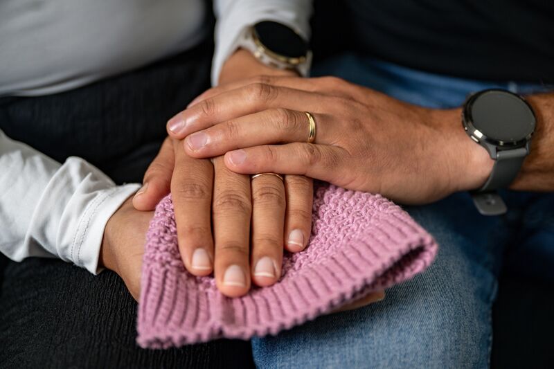 Daniela Gomez and Daniel Brenes hold a tiny hand-knitted hat made by Daniela’s mother for Alma, now kept as treasured reminders of their daughter who passed way moments after she was born. Picture: Chani Anderson Daniela Gomez and Daniel Brenes hold a tiny hand-knitted hat made by Daniela’s mother for Alma, now kept as treasured reminders of their daughter who passed way moments after she was born. Picture: Chani Anderson