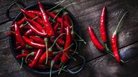 Red chili peppers shot from above on rustic wooden table