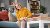 Mature adult woman experiencing knee pain at home