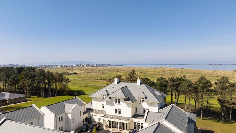 Dunluce Lodge with the fairways of the Royal Portrush Golf Club and Causeway Coast in the background Dunluce Lodge with the fairways of the Royal Portrush Golf Club and Causeway Coast in the background