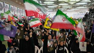 Government supporters hold Iranian flags (Vahid Salemi/AP) Government supporters hold Iranian flags (Vahid Salemi/AP)