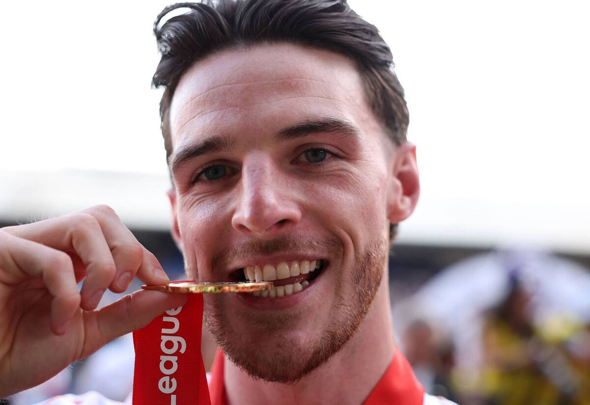 IT'S DONE: Declan Rice of Arsenal bites his Premier League winners' medal Photo by Michael Regan/Getty Images For Premier League IT'S DONE: Declan Rice of Arsenal bites his Premier League winners' medal Photo by Michael Regan/Getty Images For Premier League
