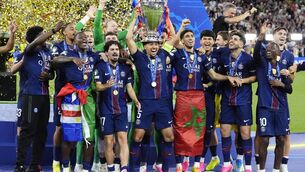 <p>Marquinhos lifts the Champions League trophy (Nick Potts/PA)</p>