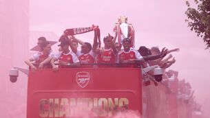 <p>PREMIER LEAGUE CHAMPS: Arsenal players celebrate winning the Premier League during an open-top bus parade (Steven Paston/PA).</p>