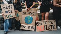 People are holding banner signs while they are going to a demonstration against climate change
