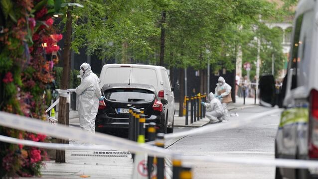 <p>Garda forensic officers at the scene of the stabbing. Picture: Niall Carson/PA Wire</p>