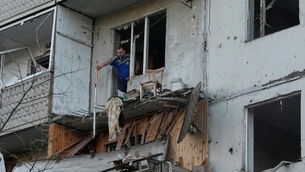 A man clears debris in his apartment building damaged after a Russian missile strike that hit in Kyiv, Ukraine, Tuesday, June 2, 2026 (Efrem Lukatsky/AP)