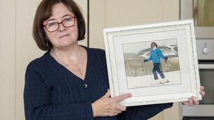 <p>Claire Clarke holding a picture of her sister Priscilla who disappeared after going horse-riding with her employer Lynda Kavanagh in Wicklow in 1988.</p>