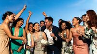 Bride and groom celebrating with their friends on beach wedding party