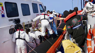 <p>Italian Coast Guard personnel evacuate migrants off the coast of the Sicilian Island of Lampedusa. File picture: Jan Salmen/AP</p>