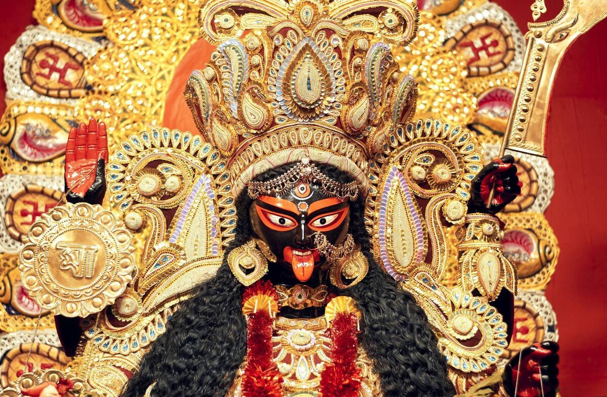 Portrait of Hindu Goddess Kali, heavily decorated with golden ornaments and zari (golden embroidery) works. Portrait of Hindu Goddess Kali, heavily decorated with golden ornaments and zari (golden embroidery) works.