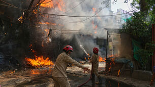 Firefighters tackle a blaze in New Delhi, India (Manish Swarup/AP)