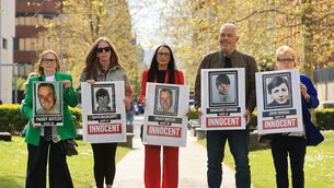 <p>Natasha Butler (centre) with relatives of those killed during the Springhill Westrock killings (Liam McBurney/PA)</p>