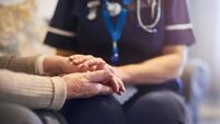 Nurse comforting patient at patient's home
