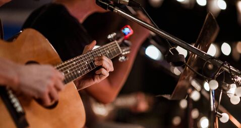 iStock-1319479564.jpg The musician plays and the lead singer sings on stage at the music festival at night.
Concert,mini concert and music festivals.