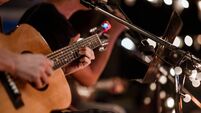 The musician plays and the lead singer sings on stage at the music festival at night.
Concert,mini concert and music festivals.