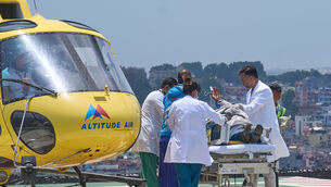 Medics take Dawa Sherpa for treatment after he arrived at HAMS Hospital in Kathmandu (Niranjan Shrestha/AP)