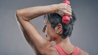 Senior woman lifting weights, maintaining fitness and health